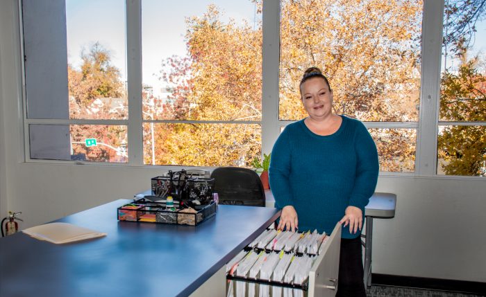 Local office worker going through filing cabinet